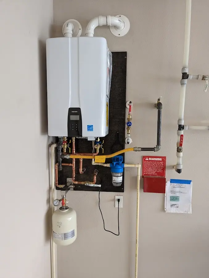 Professional plumber installing copper piping in a Frankstown home